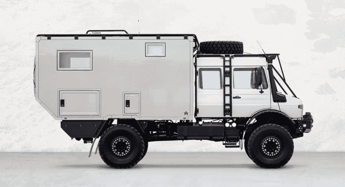Full profile of the white Arksen U1700 off-road camper showing its high ground clearance and utilitarian chassis.
