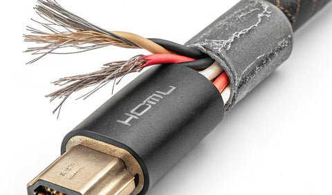 Macro shot of an HDMI connector showing the pins and the point where the cable meets the plug.