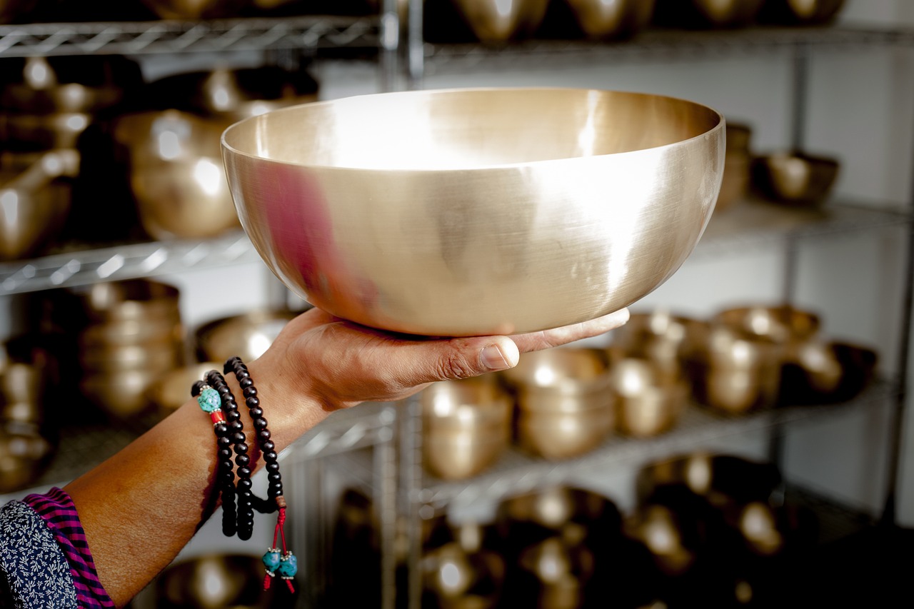 Tibetan singing bowls arranged in a serene, natural setting for a meditation session.