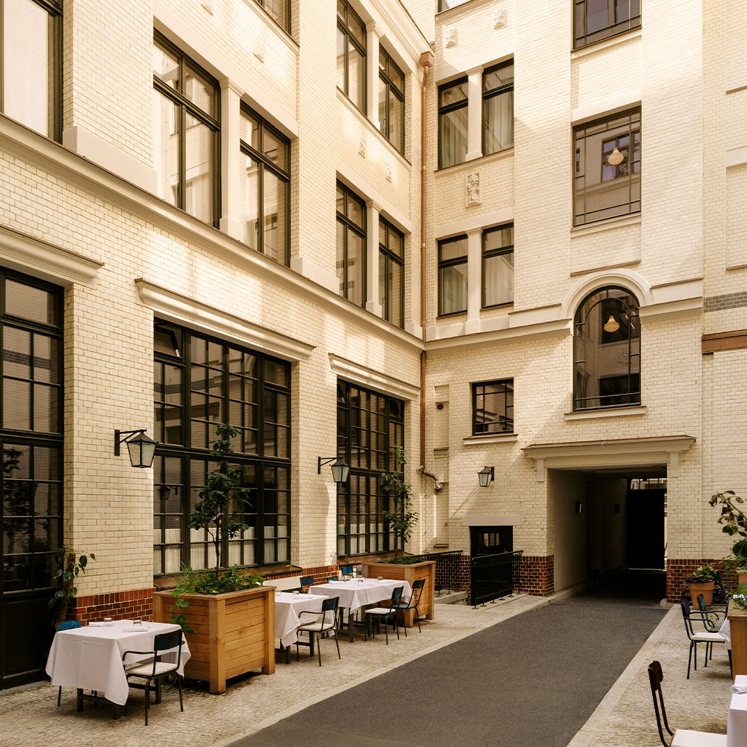 A uniquely designed room at Château Royal featuring artistic wall patterns and curated furniture.