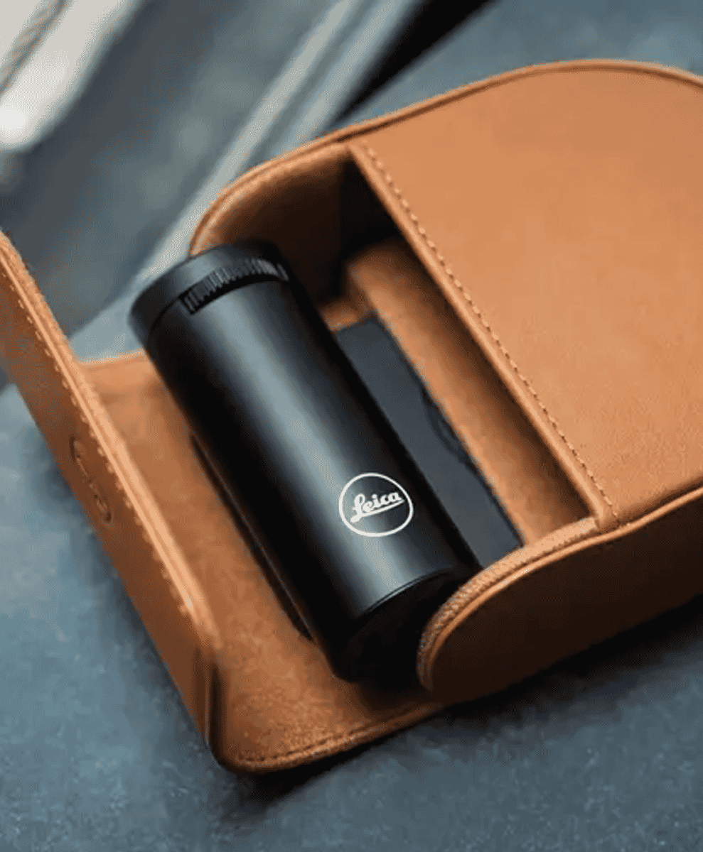 A black Leica accessory nestled inside a premium tan leather protective case.