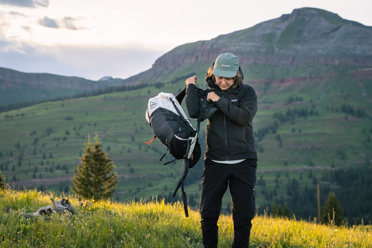 A small 30-liter fastpacking backpack with an ultralight sleeping bag tucked inside.