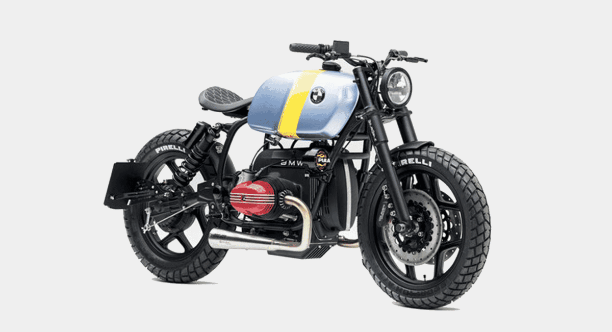 A wide studio shot of the custom BMW motorcycle highlighting its low-slung bobber stance and Pirelli tires.