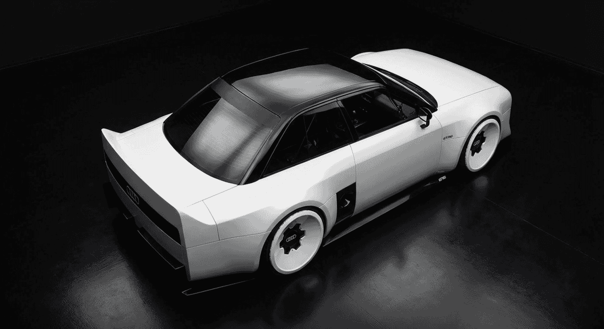 Sporty silhouette of a white Audi concept car with black accents and concave wheels in a high-contrast setting.