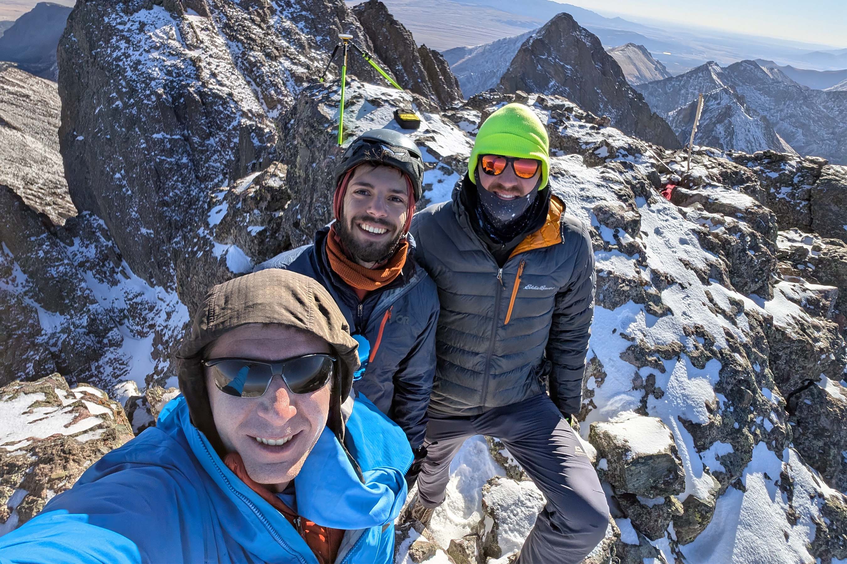 A wide scenic view from the top of a Colorado 14er looking out over adjacent rocky peaks and valleys.