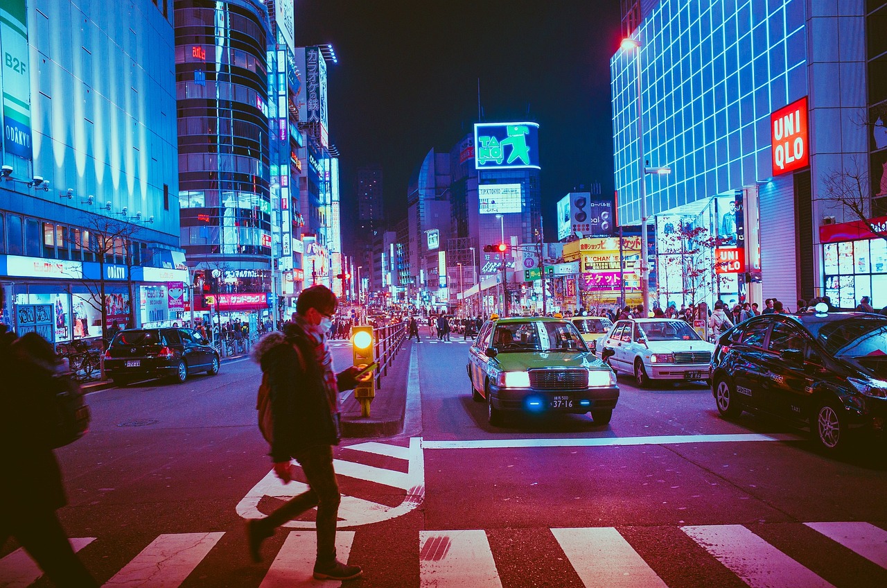 A vibrant street in Seoul at night filled with neon signs and urban energy.