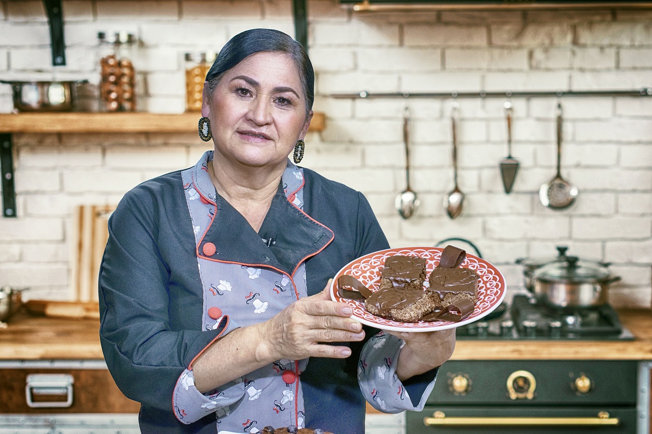 A professional chef meticulously garnishing a dish in a modern restaurant kitchen.