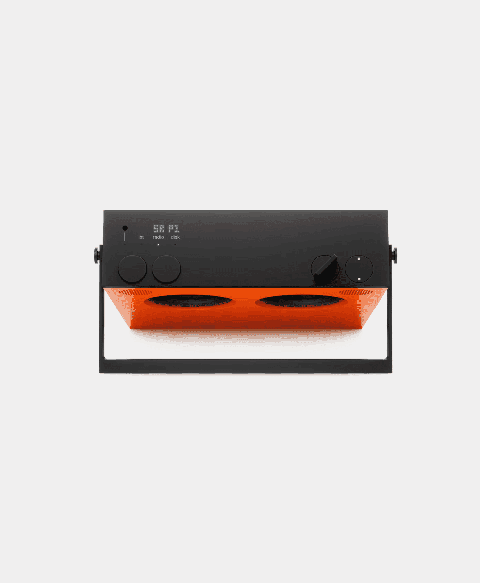 A modern black and orange speaker with dual knobs and a digital display.