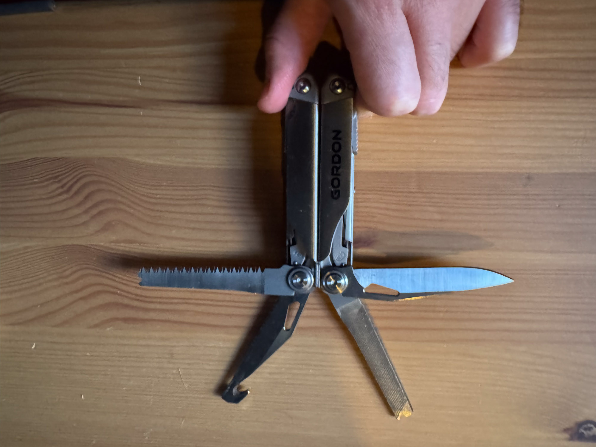 Close-up of the Gordon multi-tool's primary knife blade and locking mechanism.