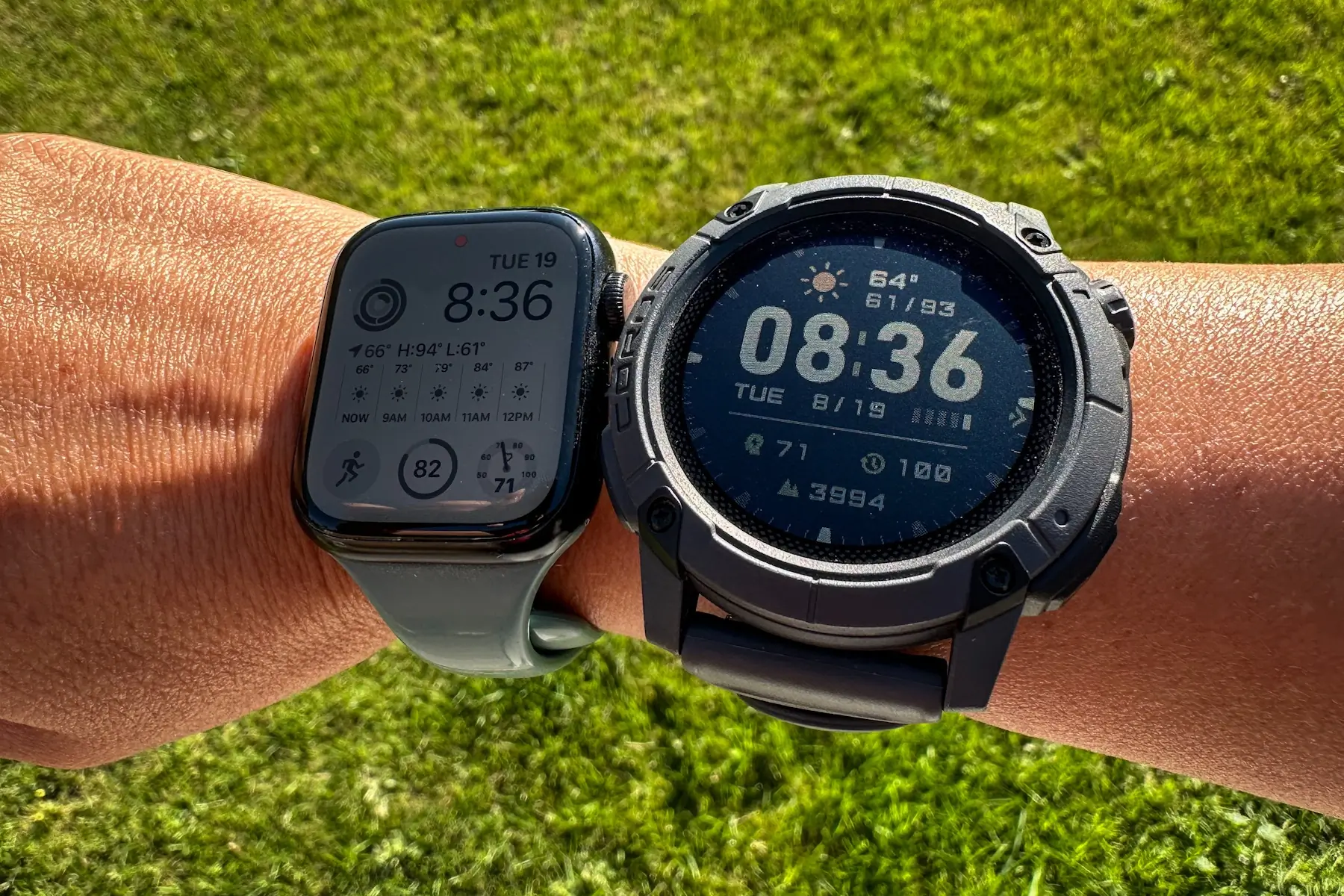 The COROS NOMAD and an Apple Watch side-by-side on a table for size comparison.