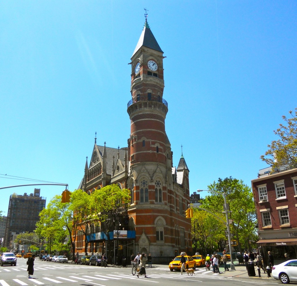 The Victorian Gothic clock tower of the Jefferson Market Library against a blue sky.