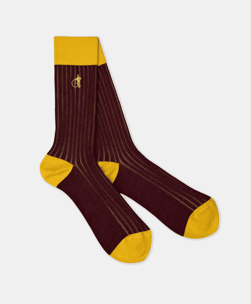 Burgundy ribbed dress socks with yellow accents and a cyclist logo on a white background.