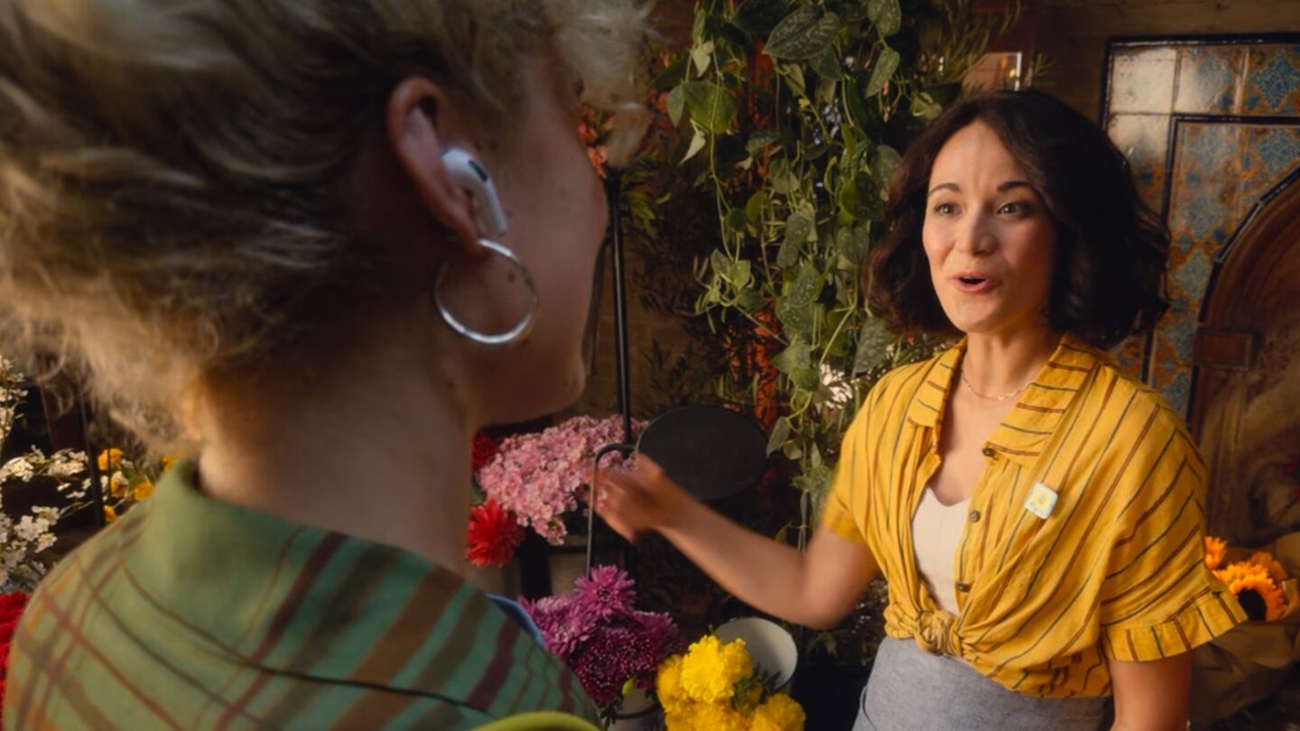 An iPhone screen showing the Live Translation interface while paired with AirPods Pro 3.