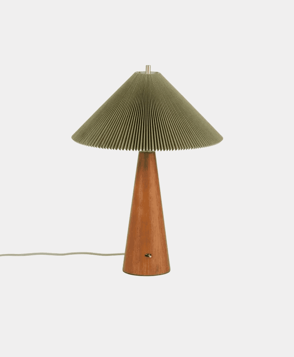 Modern table lamp with a pleated olive-green fabric shade and a tapered wooden base.