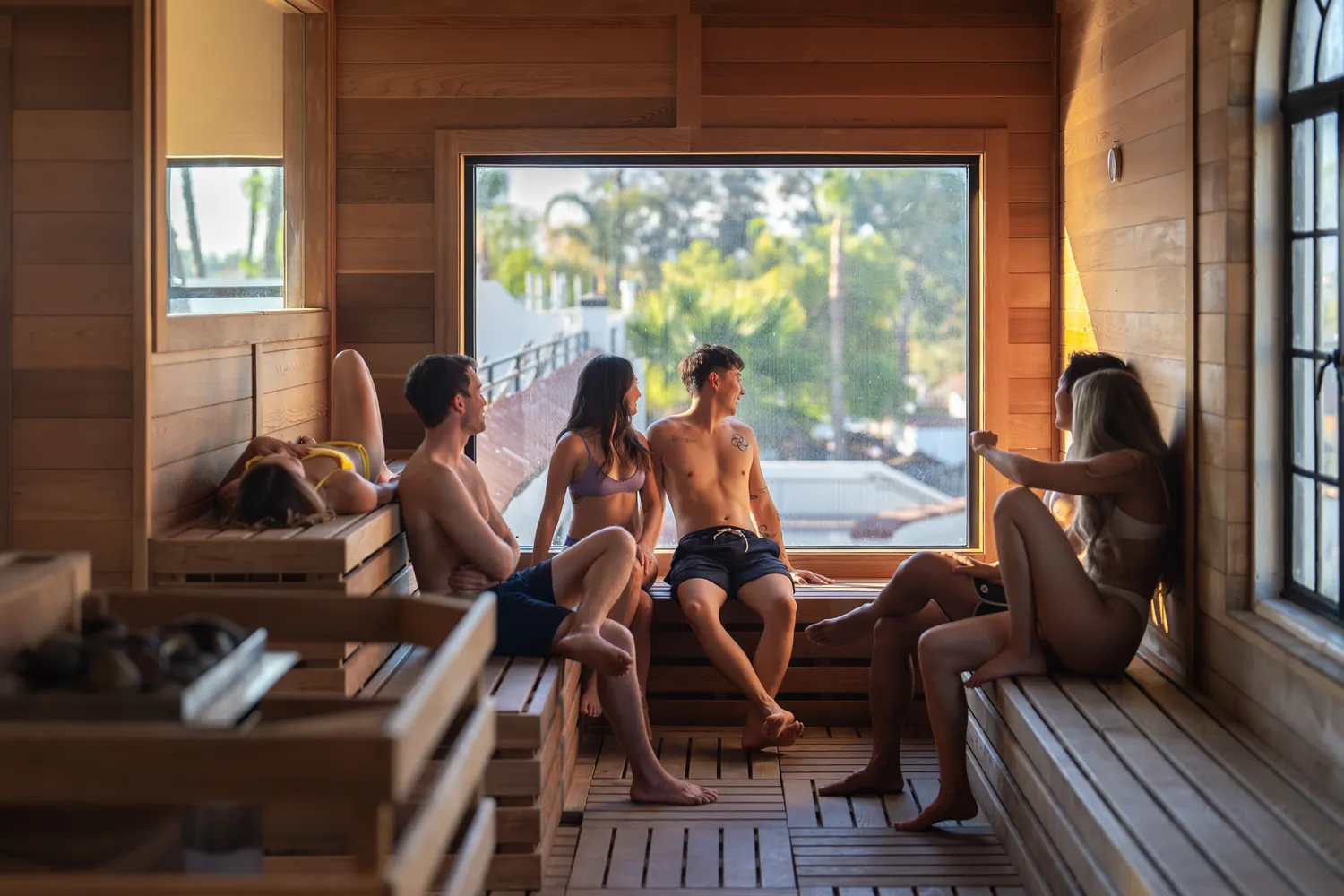 The panoramic cedar sauna provides a serene space for couples to undergo contrast therapy while enjoying the surrounding views.