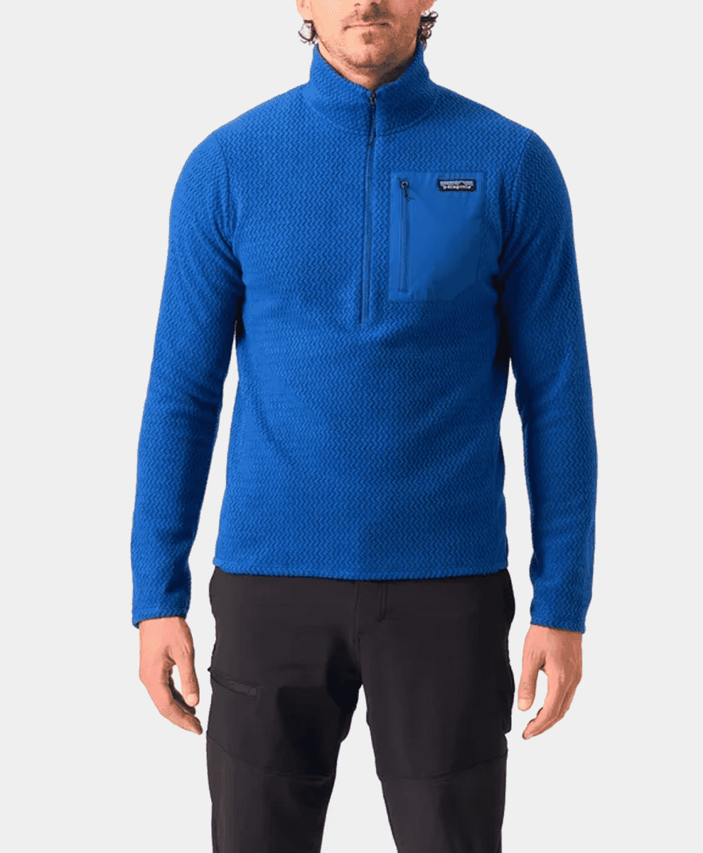 A man modeling a vibrant blue textured fleece half-zip pullover.