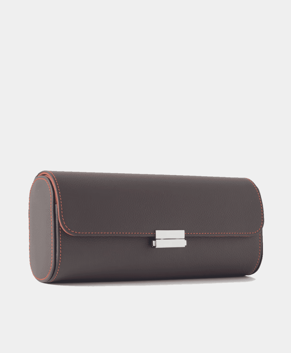 Brown leather watch roll with orange contrast stitching and silver clasp.