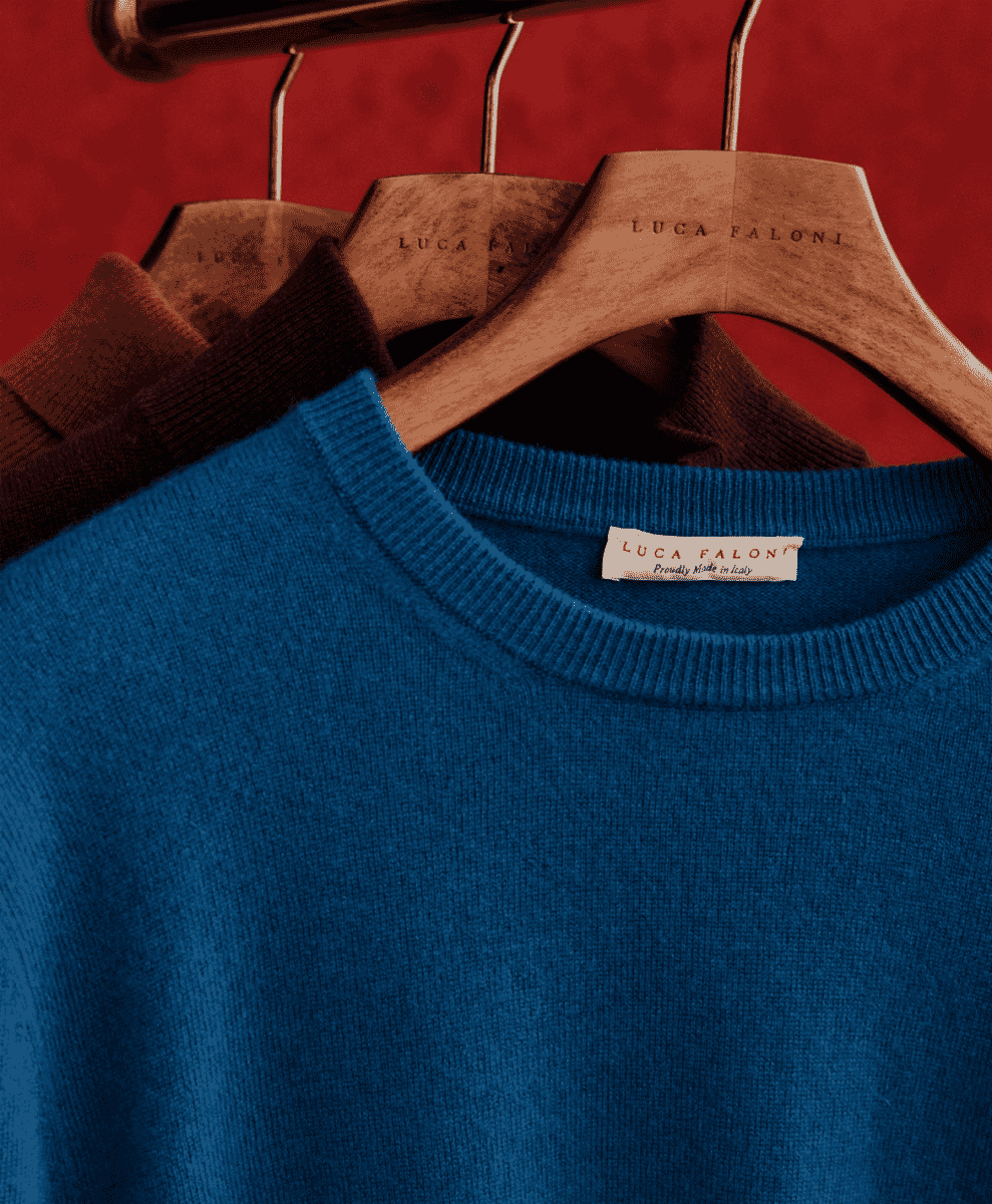 Close-up of a Luca Faloni sweater label that reads 'Proudly Made in Italy'.
