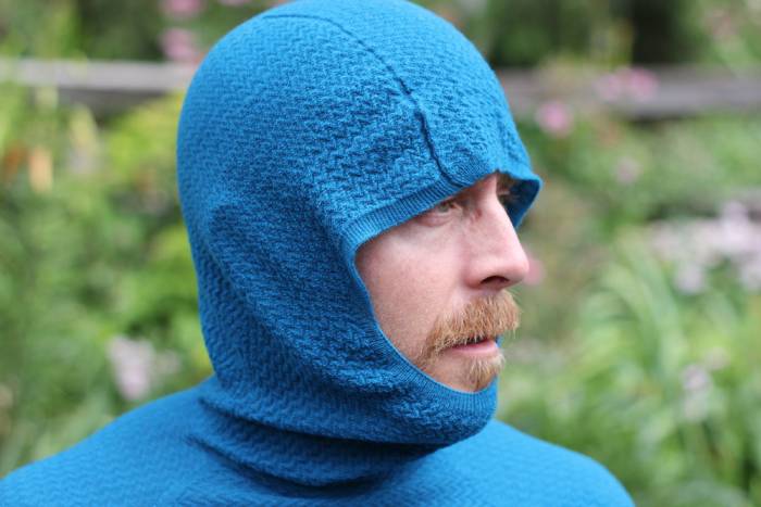 Extreme close-up of a specialized knit pattern in a performance base layer material.