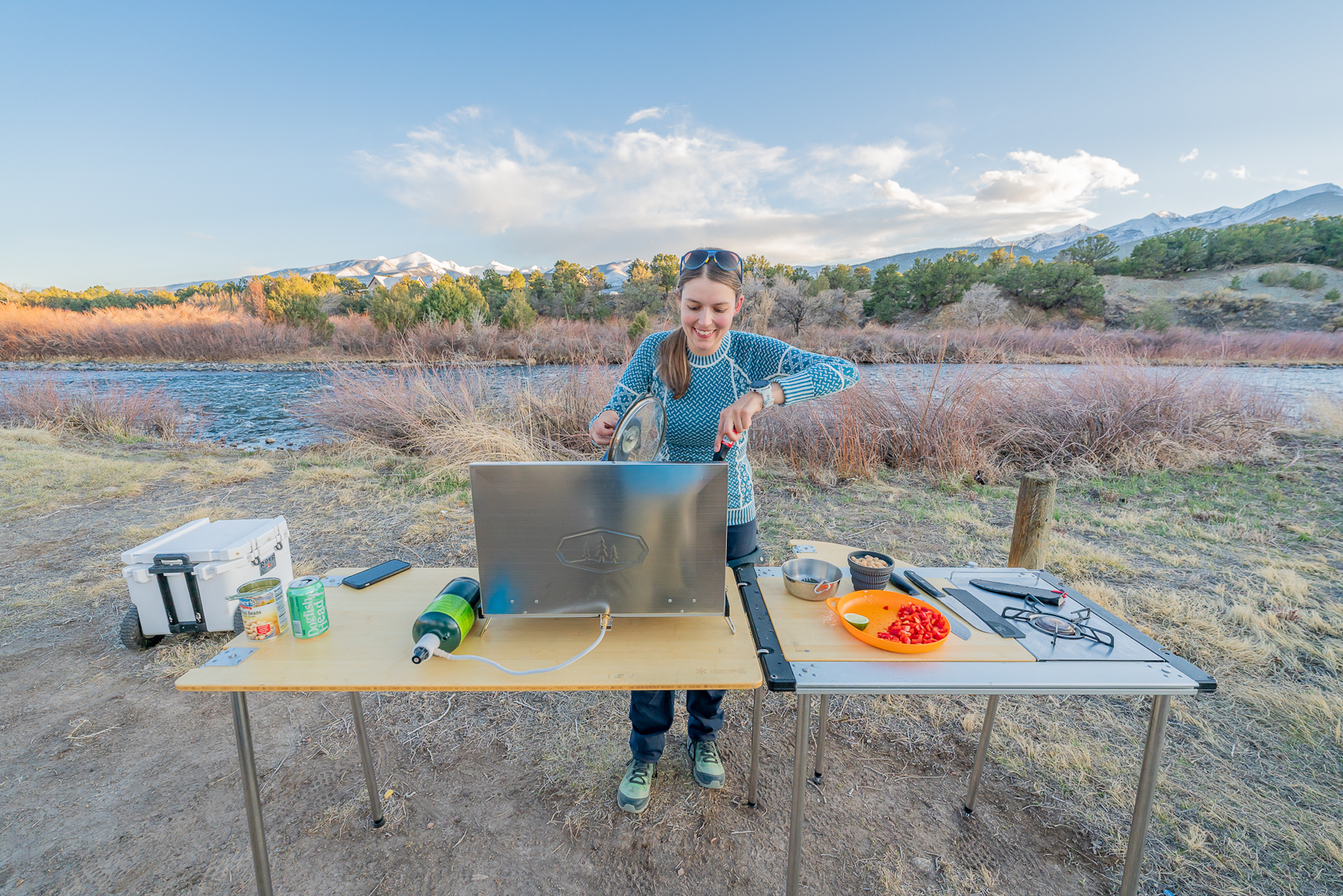 Heavy duty pans and a portable stove being used in an outdoor kitchen setup.
