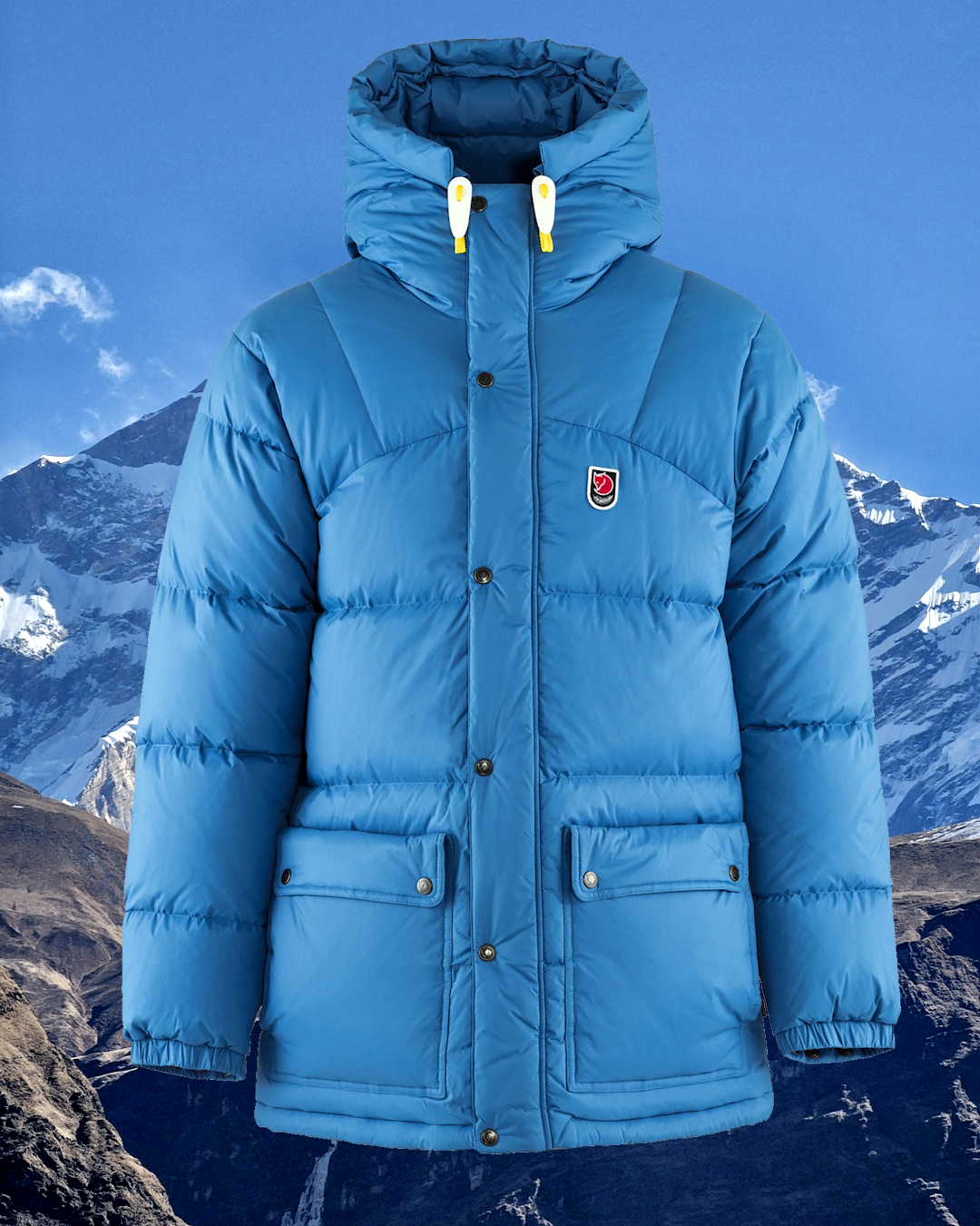 Light blue Fjällräven puffer jacket with a hood shown against a snowy mountain range.