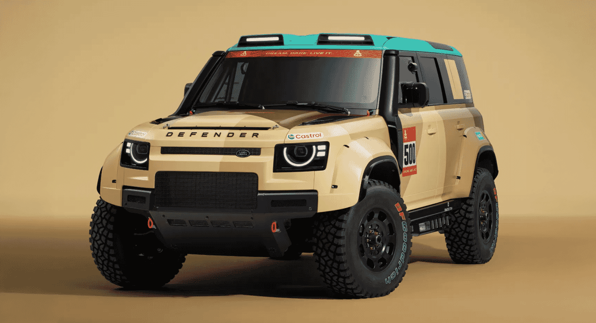 Studio shot of a beige Land Rover Defender rally vehicle with a teal roof and wide off-road tires.