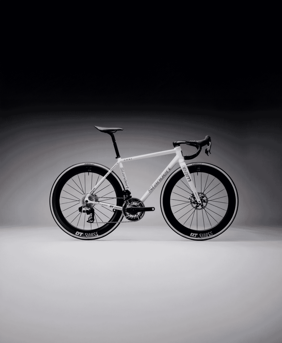 A sleek white Standert road bike with performance components in a studio setting.