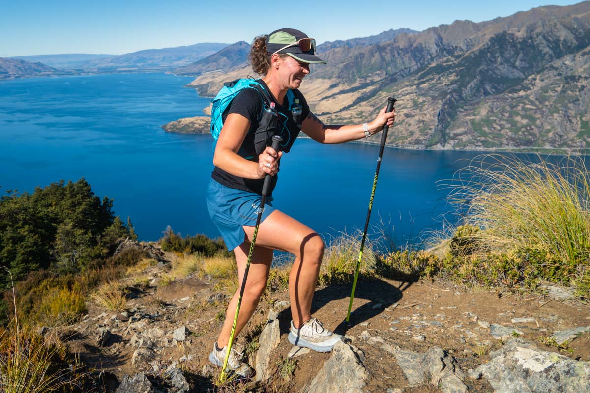 A runner on a trail wearing no-show socks on a sunny day.