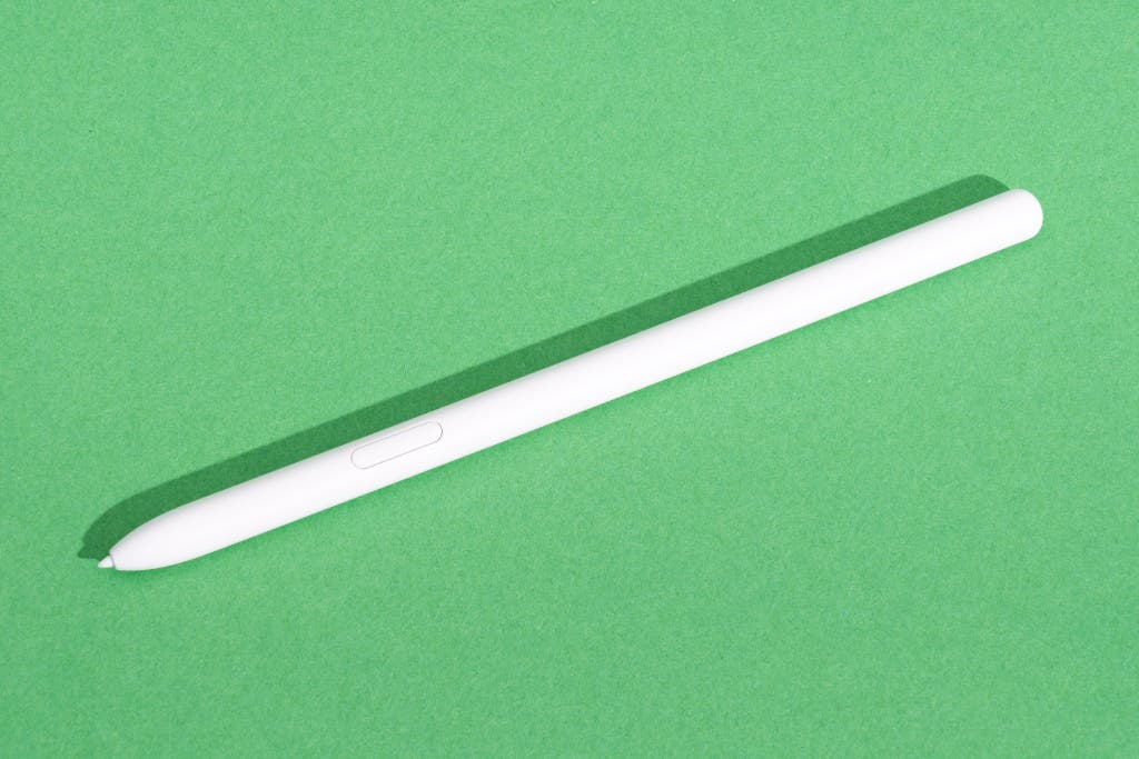 A Samsung S Pen stylus presented against a green background.