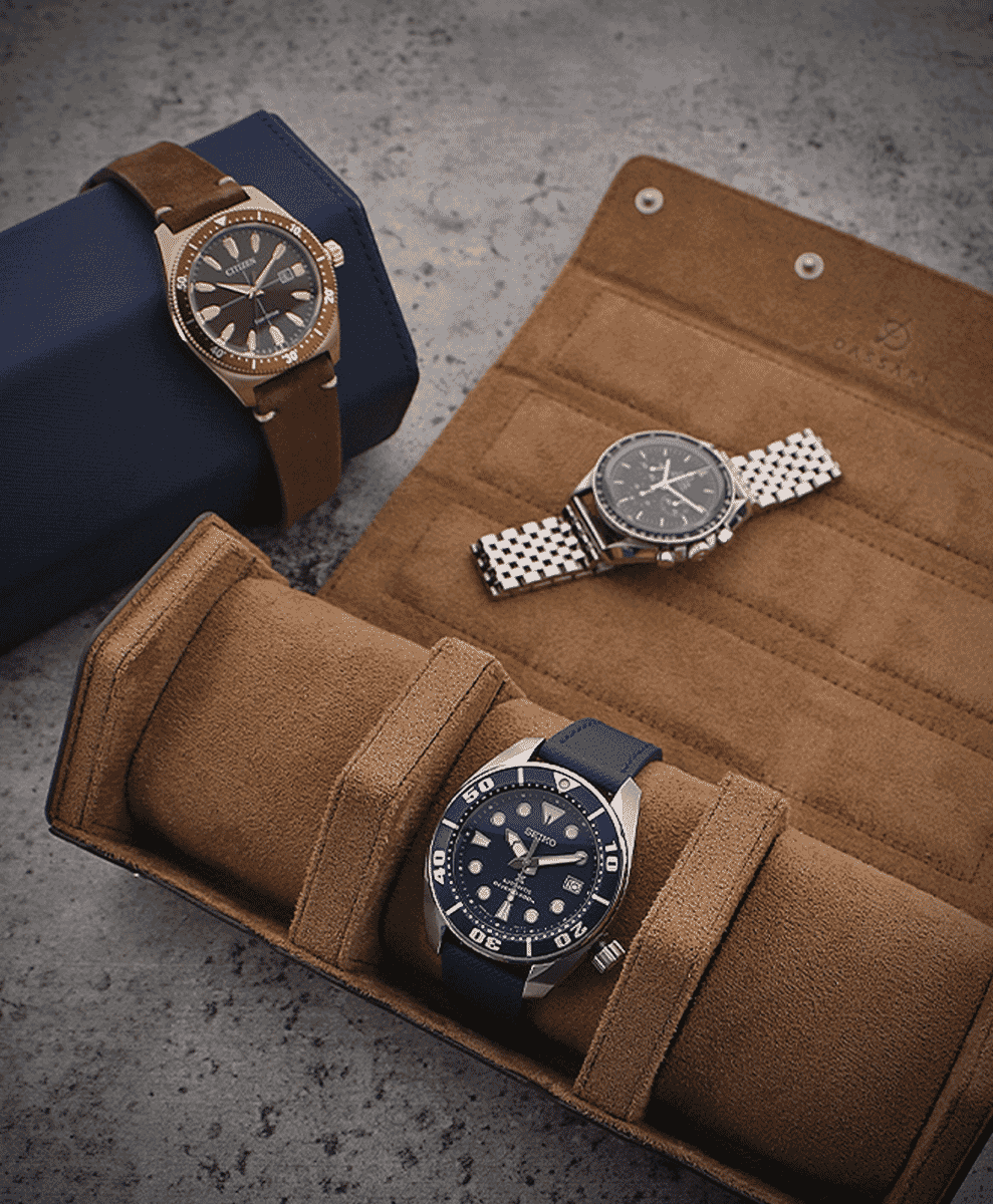 Seiko and other wristwatches displayed in a brown suede travel roll.