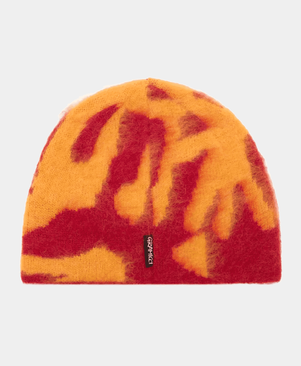 A Gramicci mohair beanie with a vibrant orange and red tie-dye pattern on a white background.