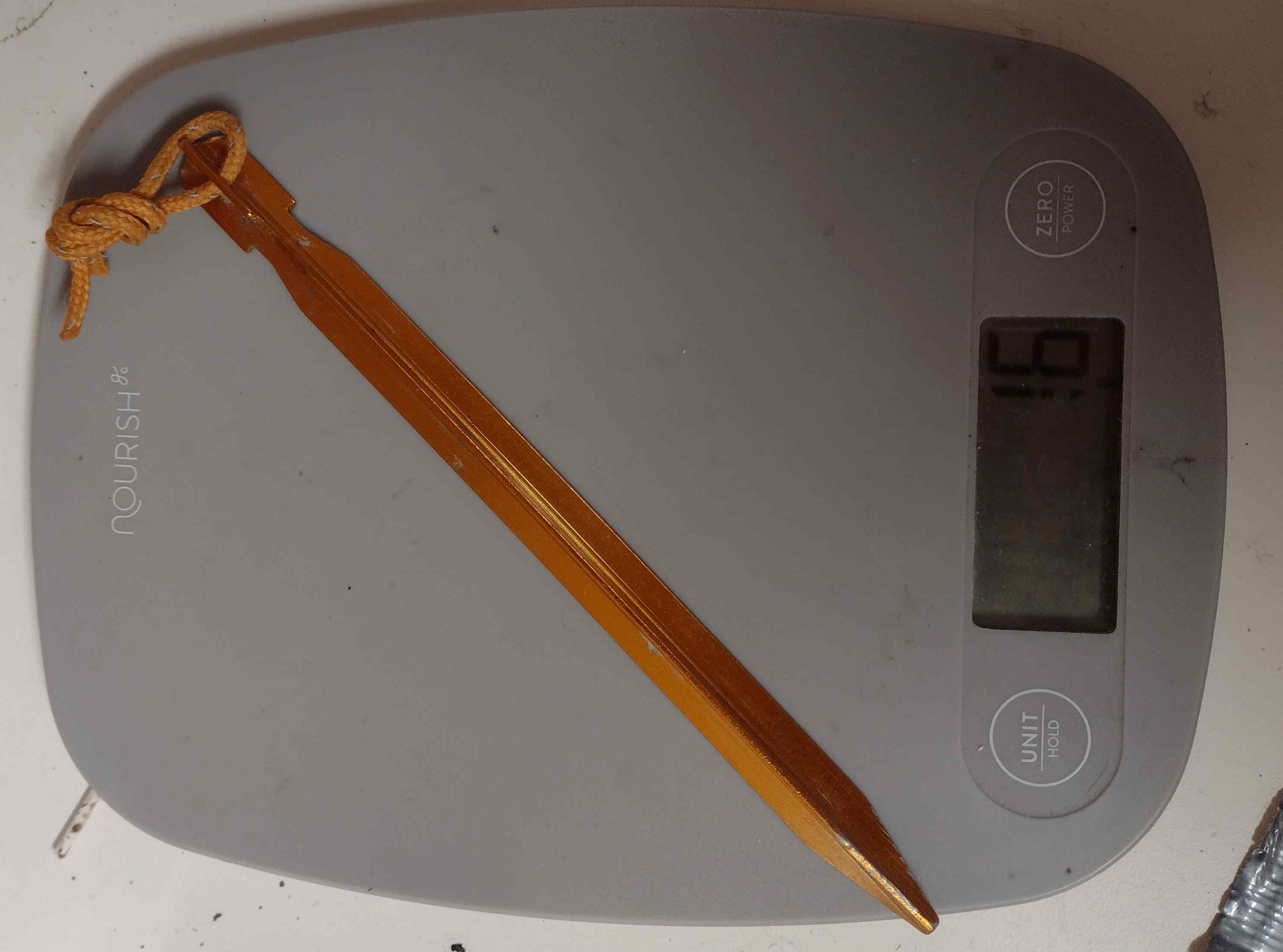 Several gold-colored Y-shaped aluminum tent stakes.