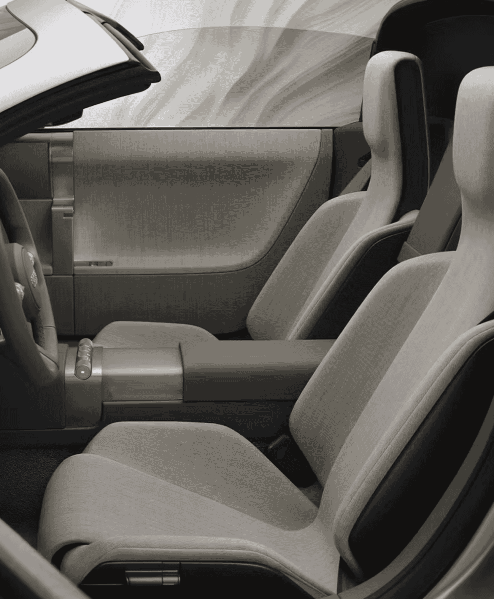 Monochrome interior of a concept car featuring light-colored seats and a minimalist dashboard.