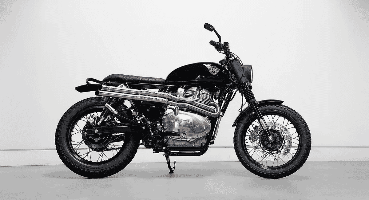 Black-and-white studio shot of a customized Royal Enfield 650 Scrambler with knobby tires.