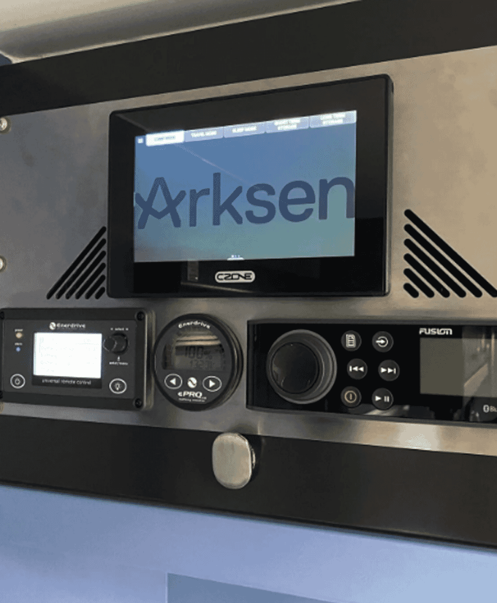 Close-up of the Arksen-branded marine control panel featuring digital displays and audio controls.