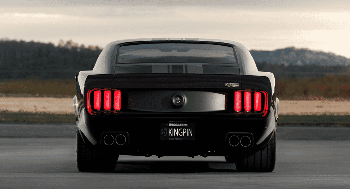 Rear view of the black Kingpin Mustang showing the custom taillights and dual Flowmaster exhausts.