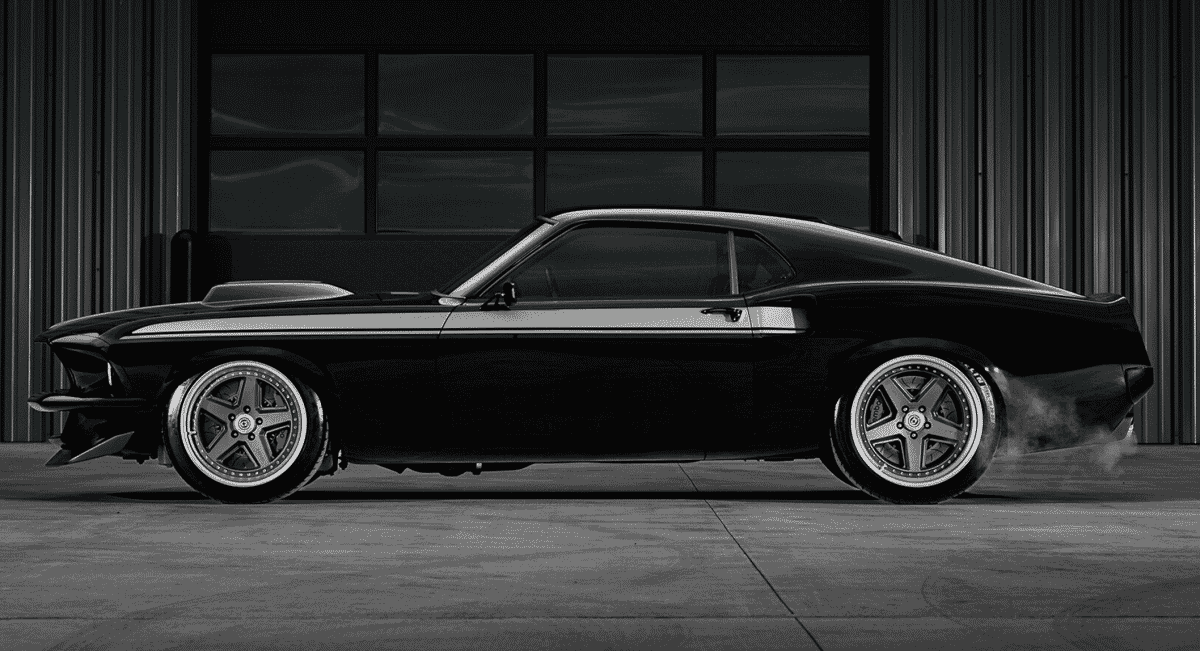Side profile of a black Mustang restomod with smoke trailing from the rear tires.