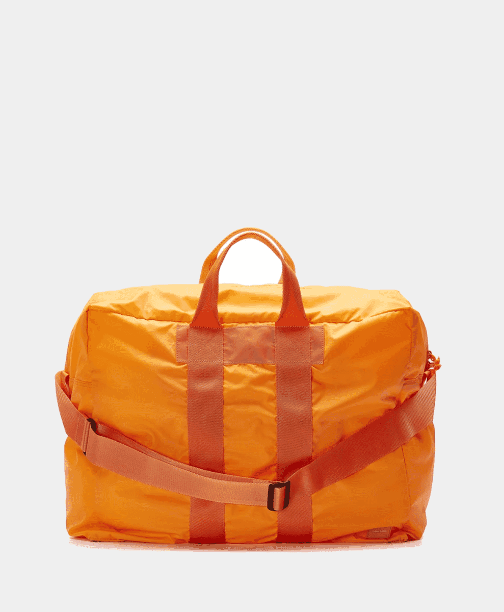 Vibrant orange Porter-Yoshida & Co. duffel bag on a white background.