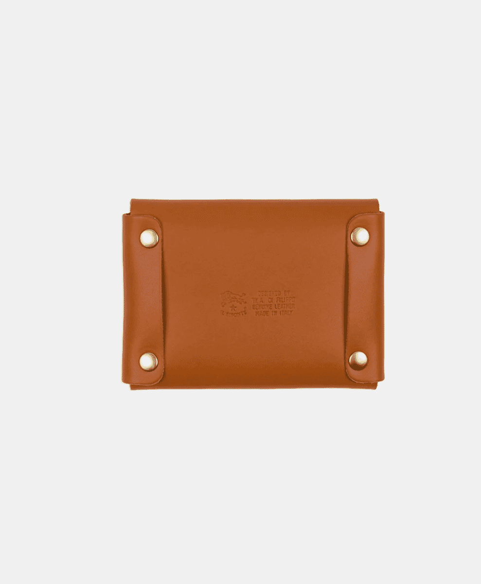 Tan leather card case with embossed Il Bisonette branding and brass rivets.
