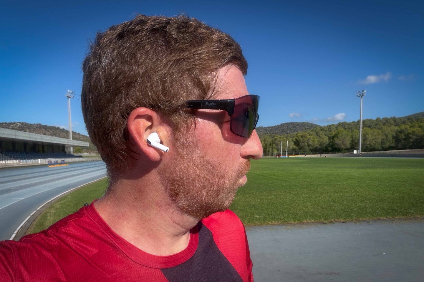Close-up side view of an AirPods Pro 3 earbud seated in a user's ear.