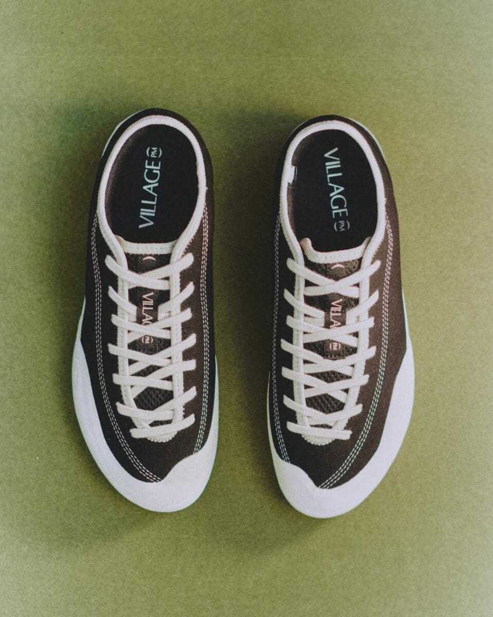 Top-down view of black and white Village PM sneakers highlighting the asymmetrical toe design.