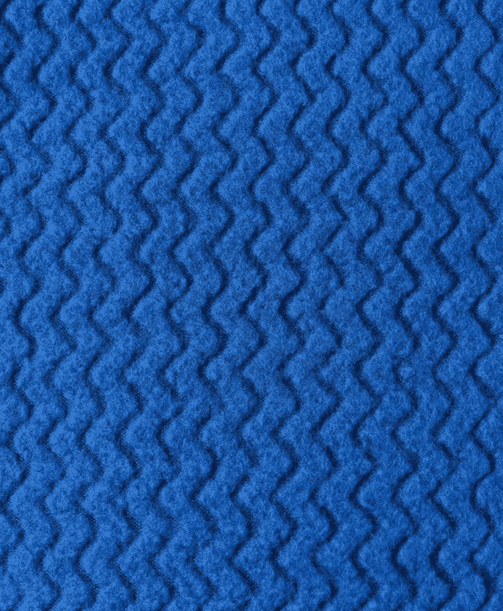 Macro shot of a vibrant blue fabric with a distinct zigzag textured pattern.
