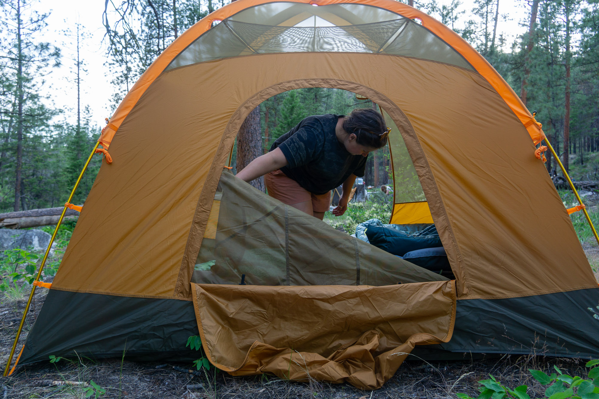 A camping tent being tested for waterproofing during a heavy rain storm.