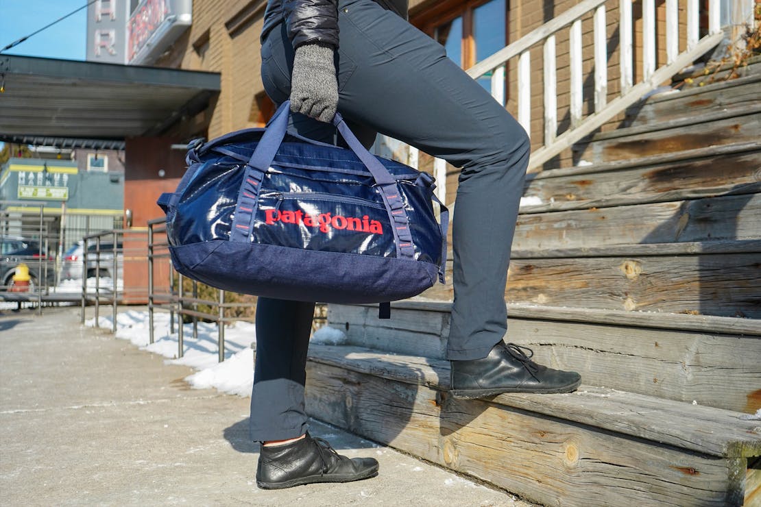 A Patagonia Black Hole Duffel Bag 40L in an urban setting.