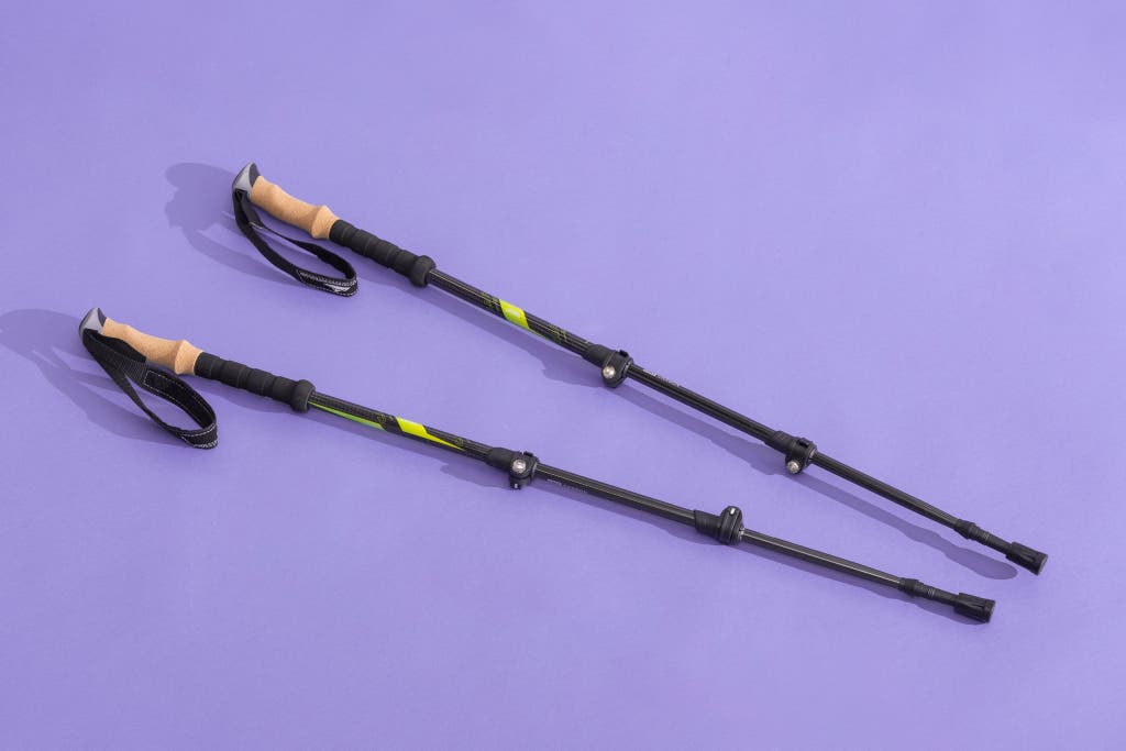 Cascade Mountain Tech Carbon Fiber Trekking Poles with quick-lock mechanisms on a purple background.