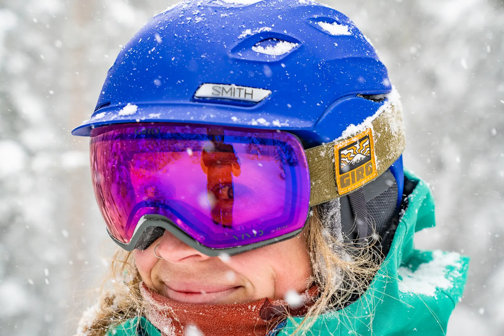 A woman wearing ski goggles with yellow low-light lenses during a snowstorm.