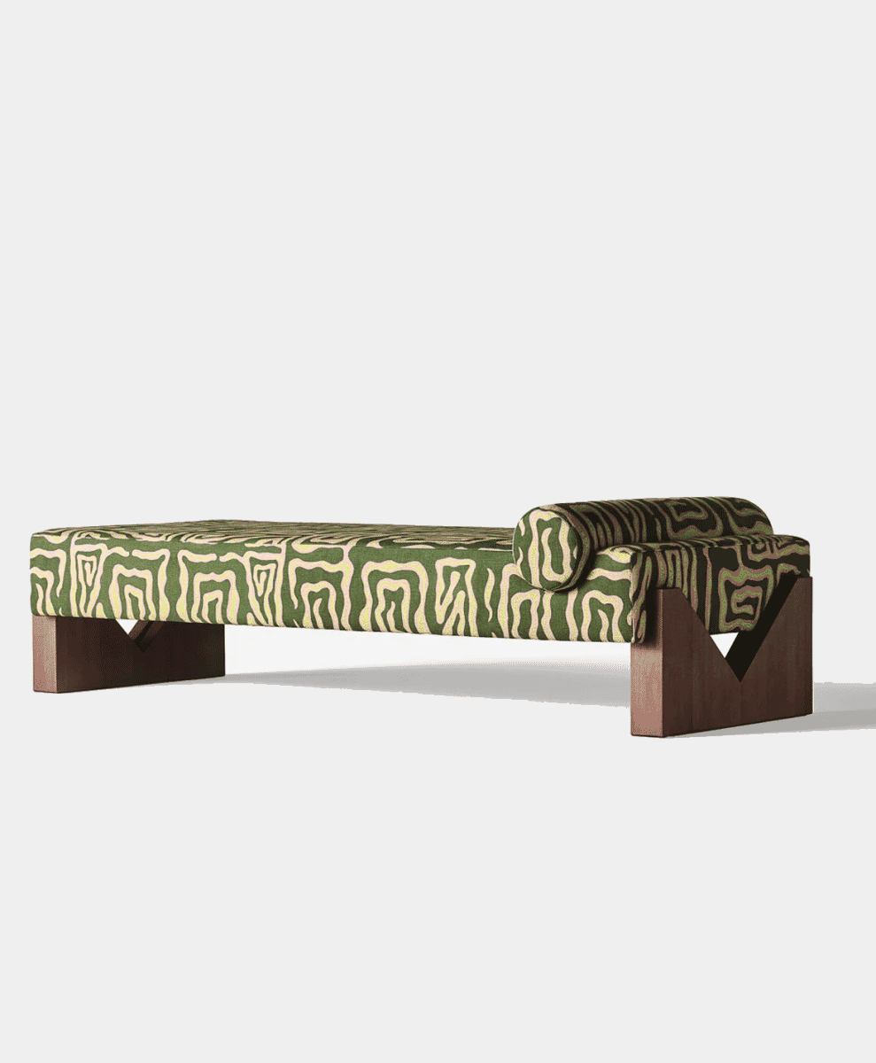 Modern chaise lounge with green and cream abstract patterned upholstery and dark wooden legs.