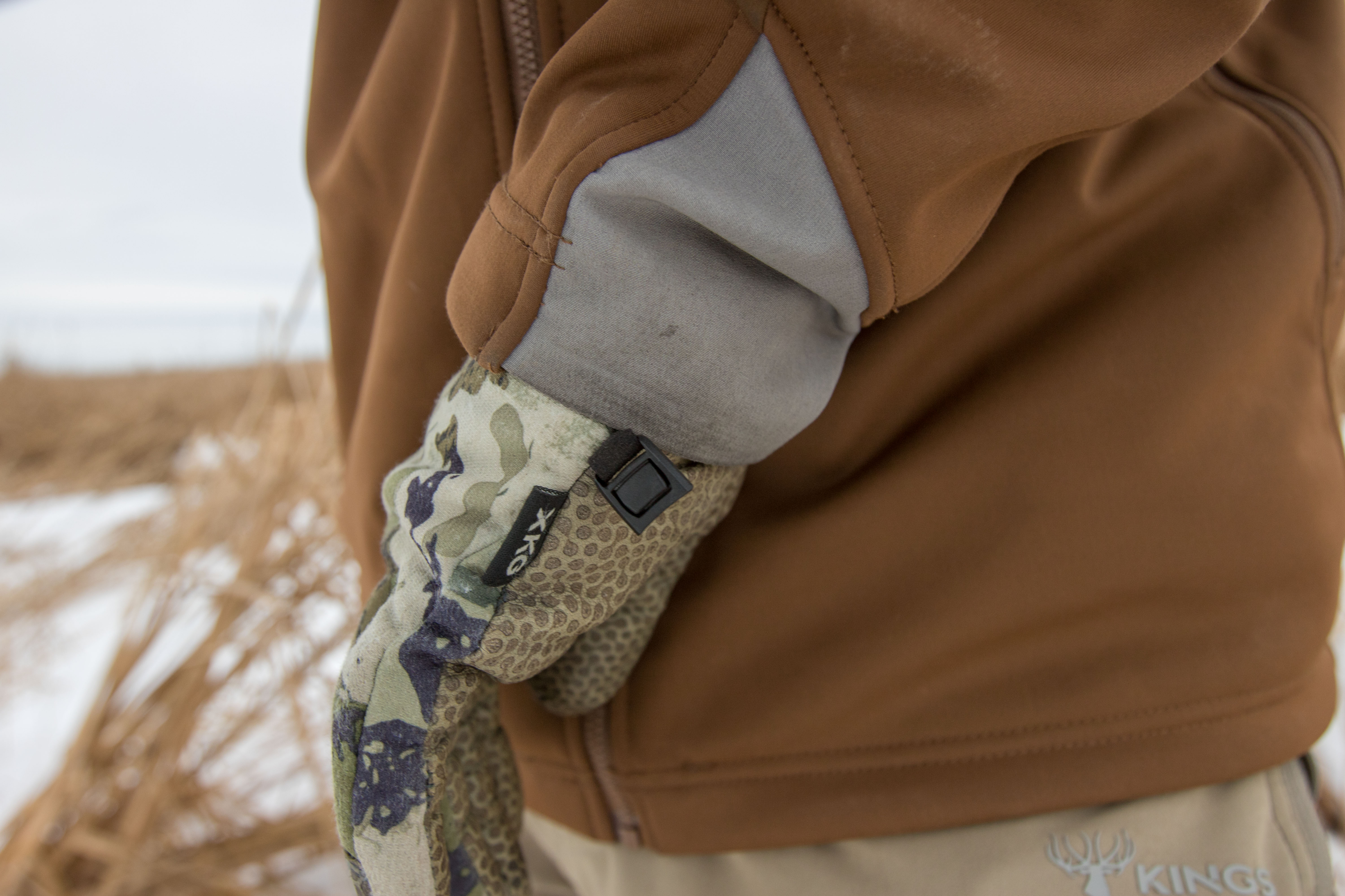 Close-up of the elastic cuff of the SITKA Jetstream jacket near a gloved hand.