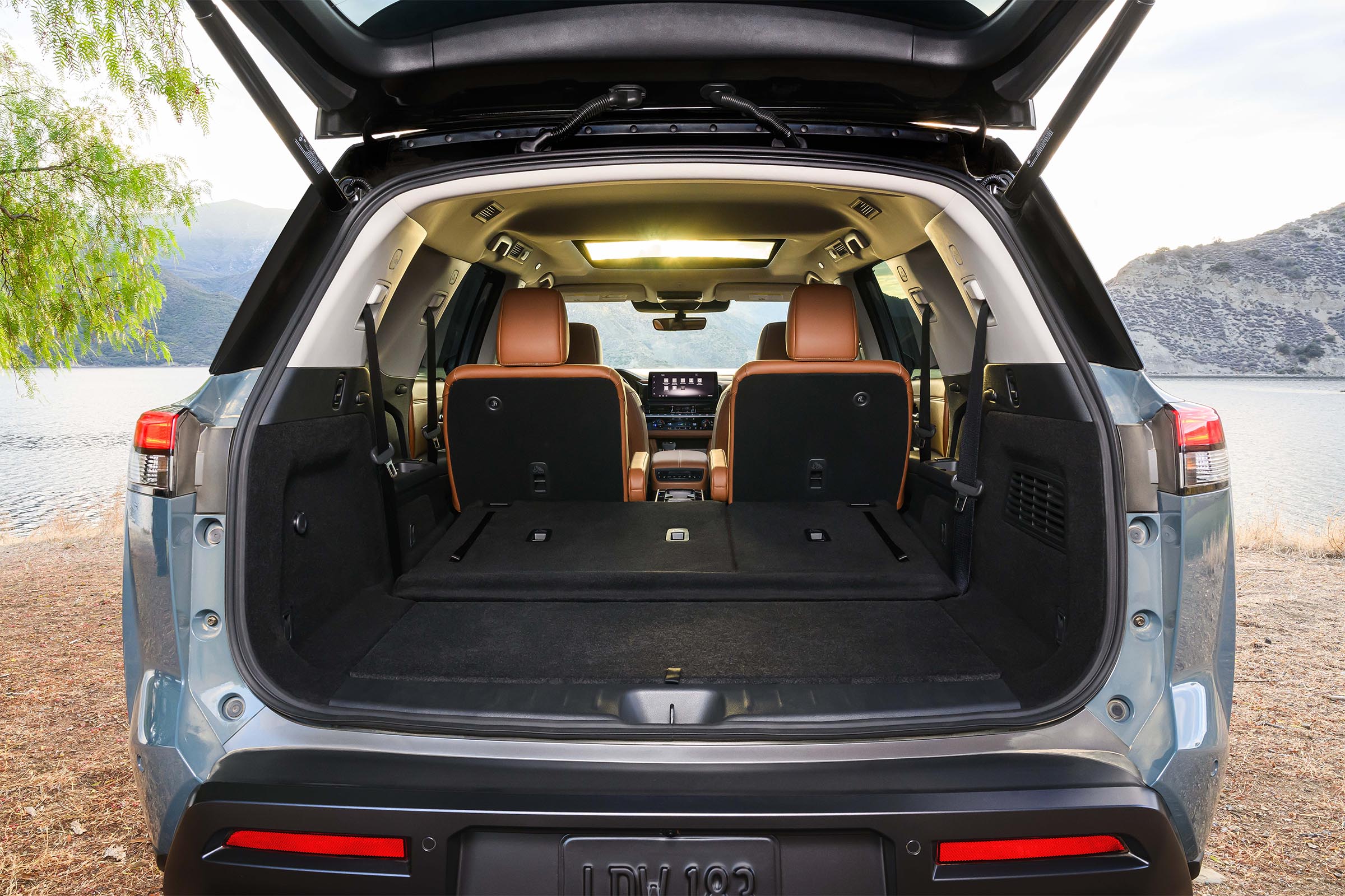 The rear cargo area of a 2026 Nissan Pathfinder with the second and third-row seats folded flat to reveal a large storage space.