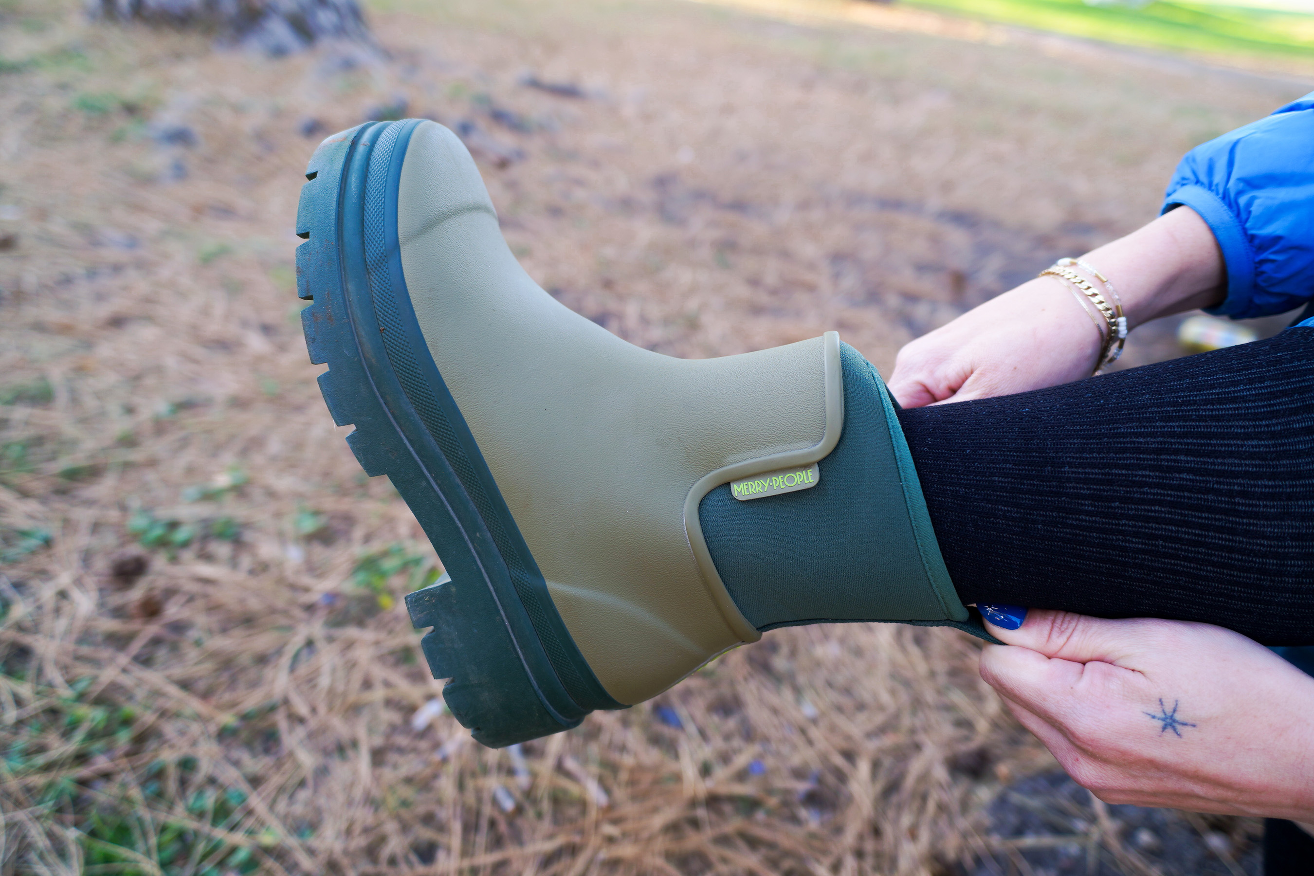 A close-up shot focusing on the waterproof rubber exterior of the Merry People Tully Rain Boot.